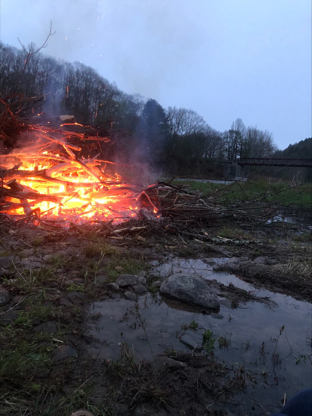 Riverside bonfire at dusk