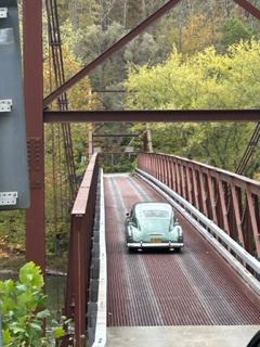 Vintage green car crossing the Soaring Eagle bridge